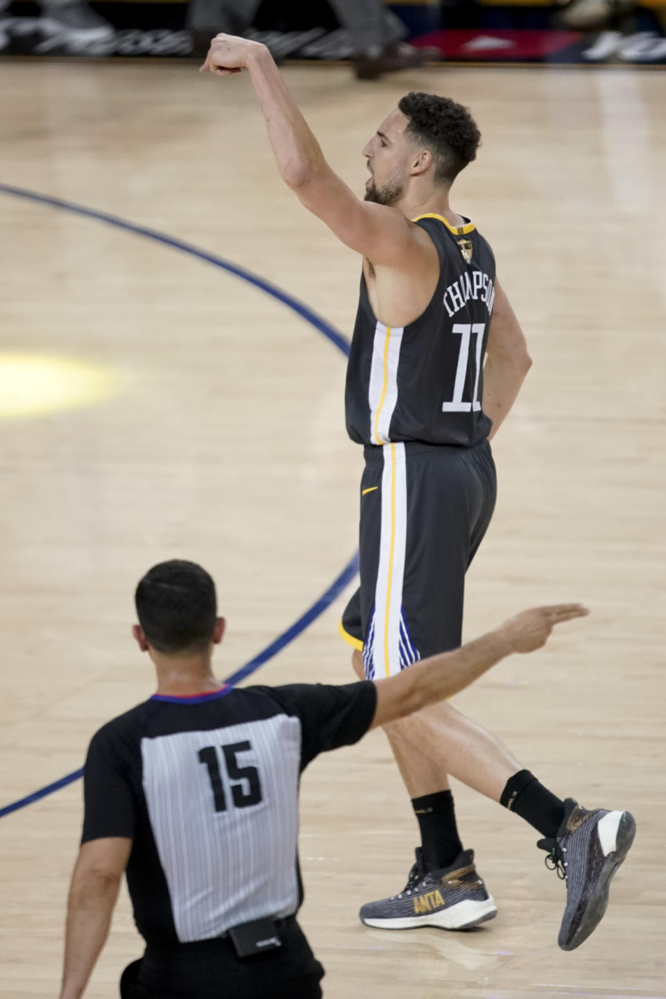 Golden State Warriors guard Klay Thompson (11) reacts after scoring against the Toronto Raptors during the first half of Game 4 of basketball's NBA Finals in Oakland, Calif., Friday, June 7, 2019. (AP Photo/Tony Avelar)