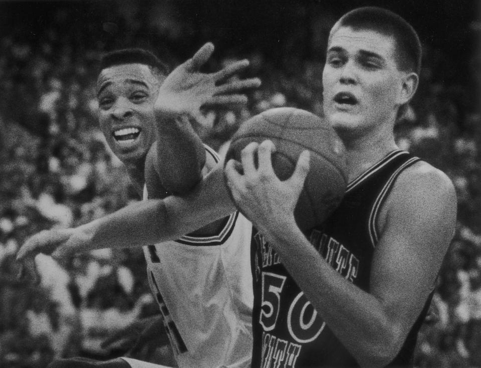 Brian Evans (50) of Terre Haute South holds off Brebeuf's Alan Henderson for a rebound, March 23, 1991.