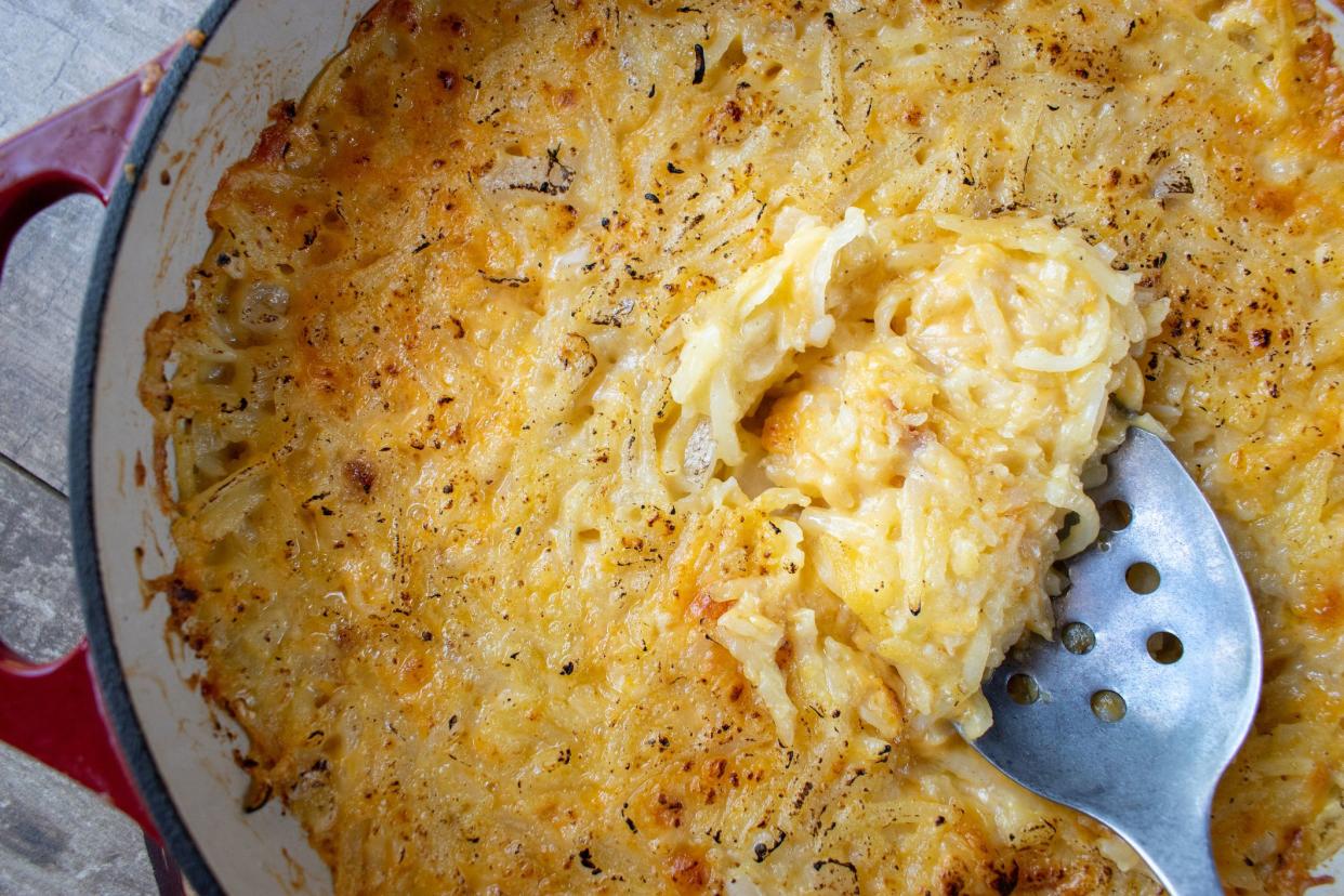 Cheesy potato hash browns in cast iron dish flat lay