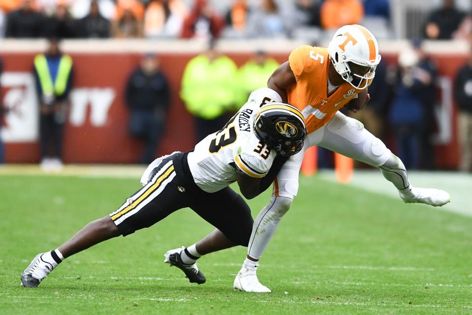 Tennessee quarterback Hendon Hooker (5 )is pulled down by Missouri linebacker Chad Bailey (33) during the NCAA college football game on Saturday, November 12, 2022 in Knoxville, Tenn.