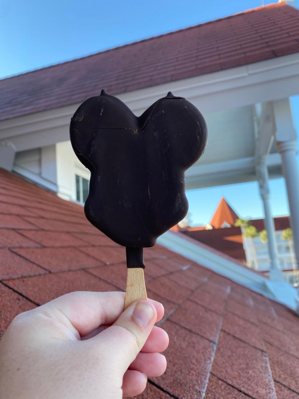 hand holding mickey premium ice cream bar at a disney resort