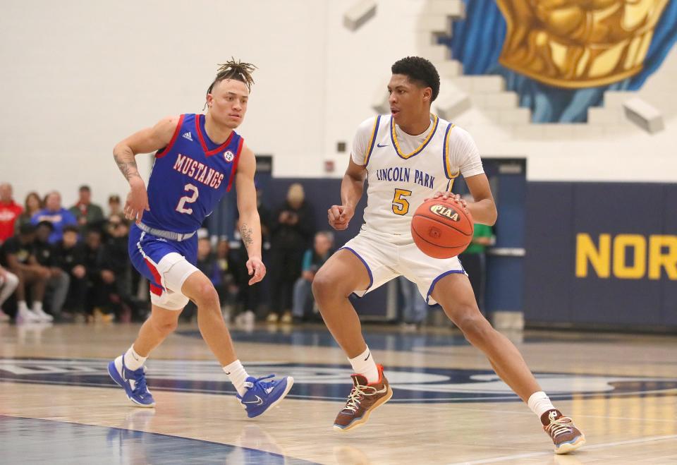 Lincoln Park's Meleek Thomas (5) prepares to drive to the basket after getting around Laurel Highland's Rodney Gallagher (2) during the first half of the PIAA 4A Quarterfinals game Friday night at Hampton High School in Allison Park, PA.