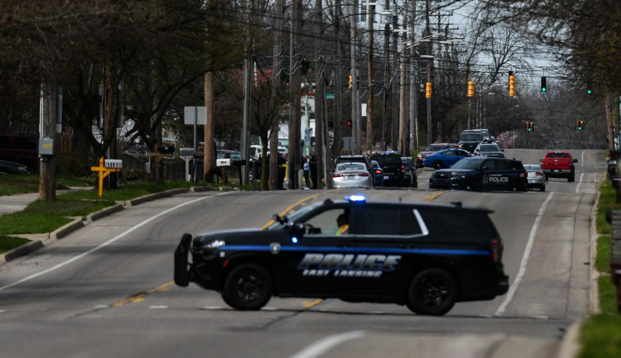 A heavy police presence and crime scene tape near West Holmes Road and Simken Drive in Lansing, Wednesday, April 10, 2024.