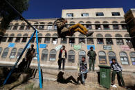 A boy plays on a swing as others watch in a yard of an orphanage in Sanaa, Yemen, January 2, 2017. REUTERS/Khaled Abdullah