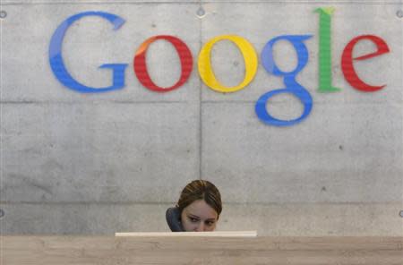 An employee answers phone calls at the switchboard of the Google office in Zurich August 18, 2009. REUTERS/Christian Hartmann