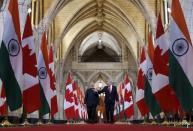 Canada's Prime Minister Stephen Harper (R) walks in the Hall of Honour with India's Prime Minister Narendra Modi on Parliament Hill in Ottawa April 15, 2015. REUTERS/Chris Wattie