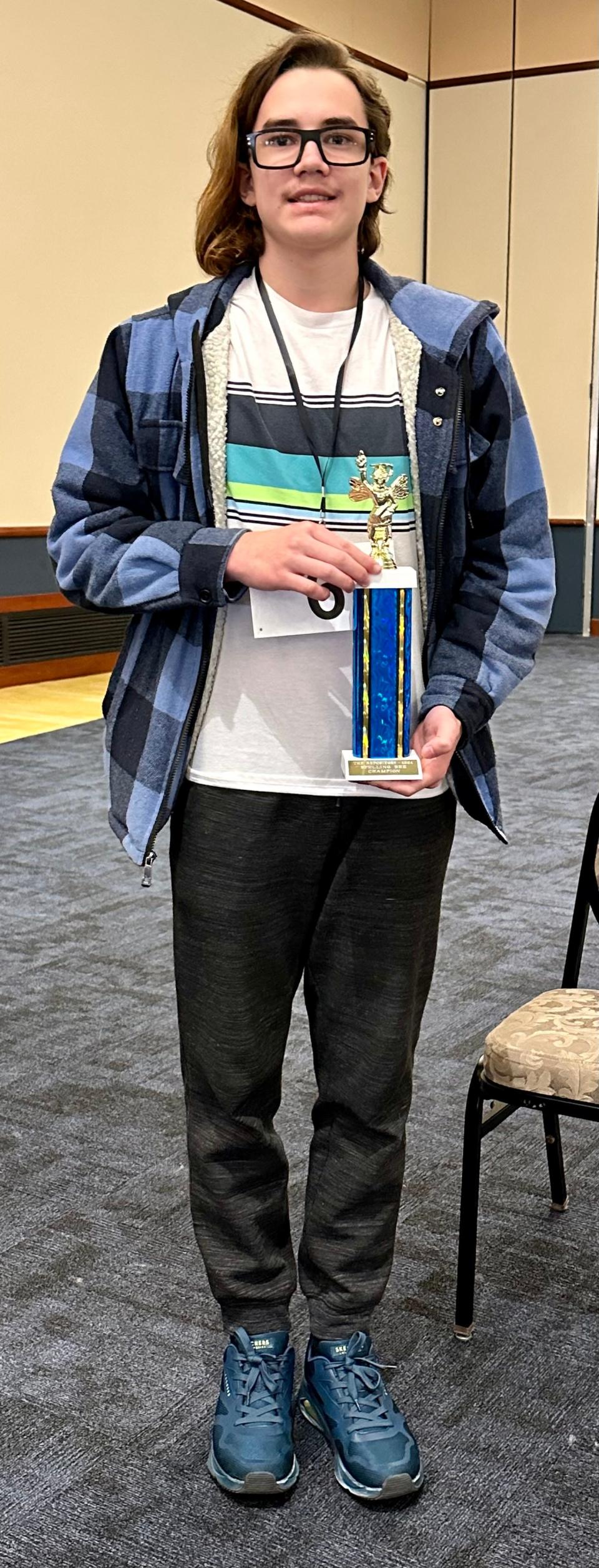 Logan Cox of Claymont Junior High School in Uhrichsville holds his trophy after winning The Canton Repository's 78th Regional Final Spelling Bee on Saturday, March 16, 2024, at Kent State University at Stark.