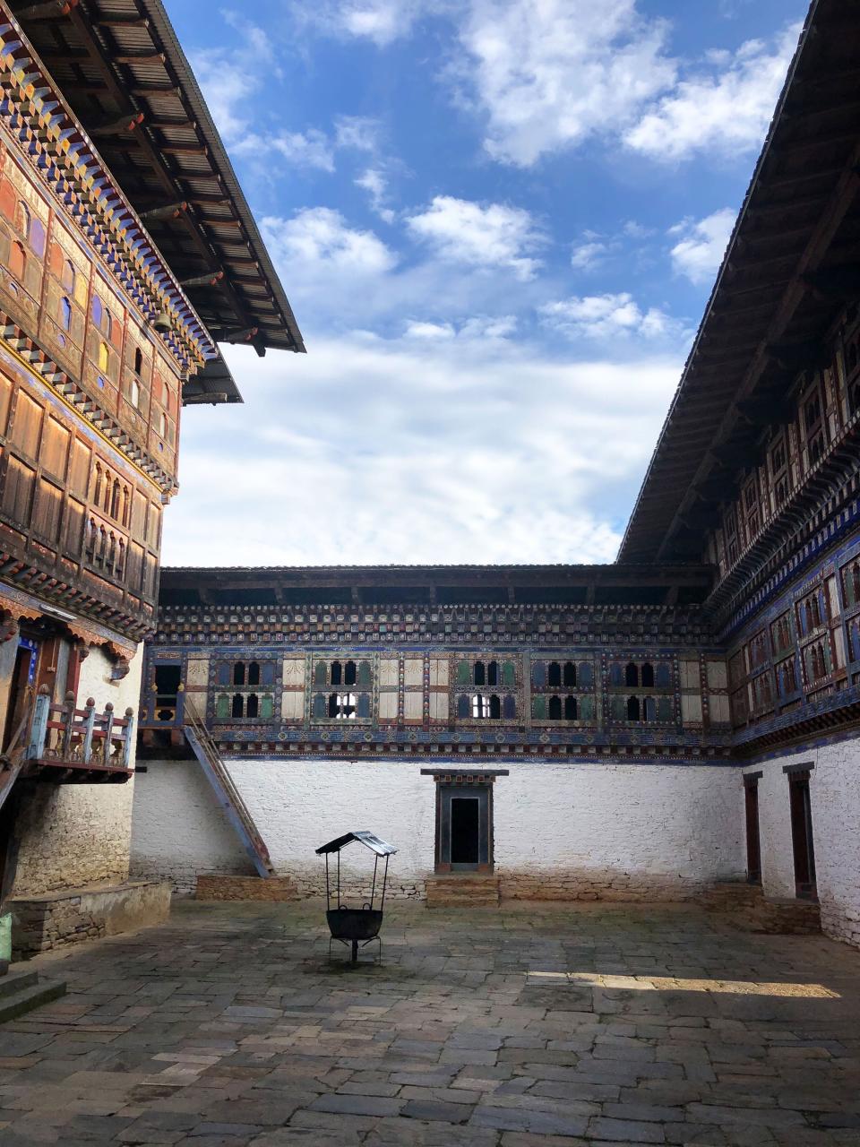 A view of the courtyard of Bhutan's 19th-century Wangduechhoeling Palace—located in the country's central Bumthang Valley, which is filled with Buddhist monasteries, ancient temples, and shrines—looking south, with an utse—a tower that contains the palace's sacred shrine—at left.