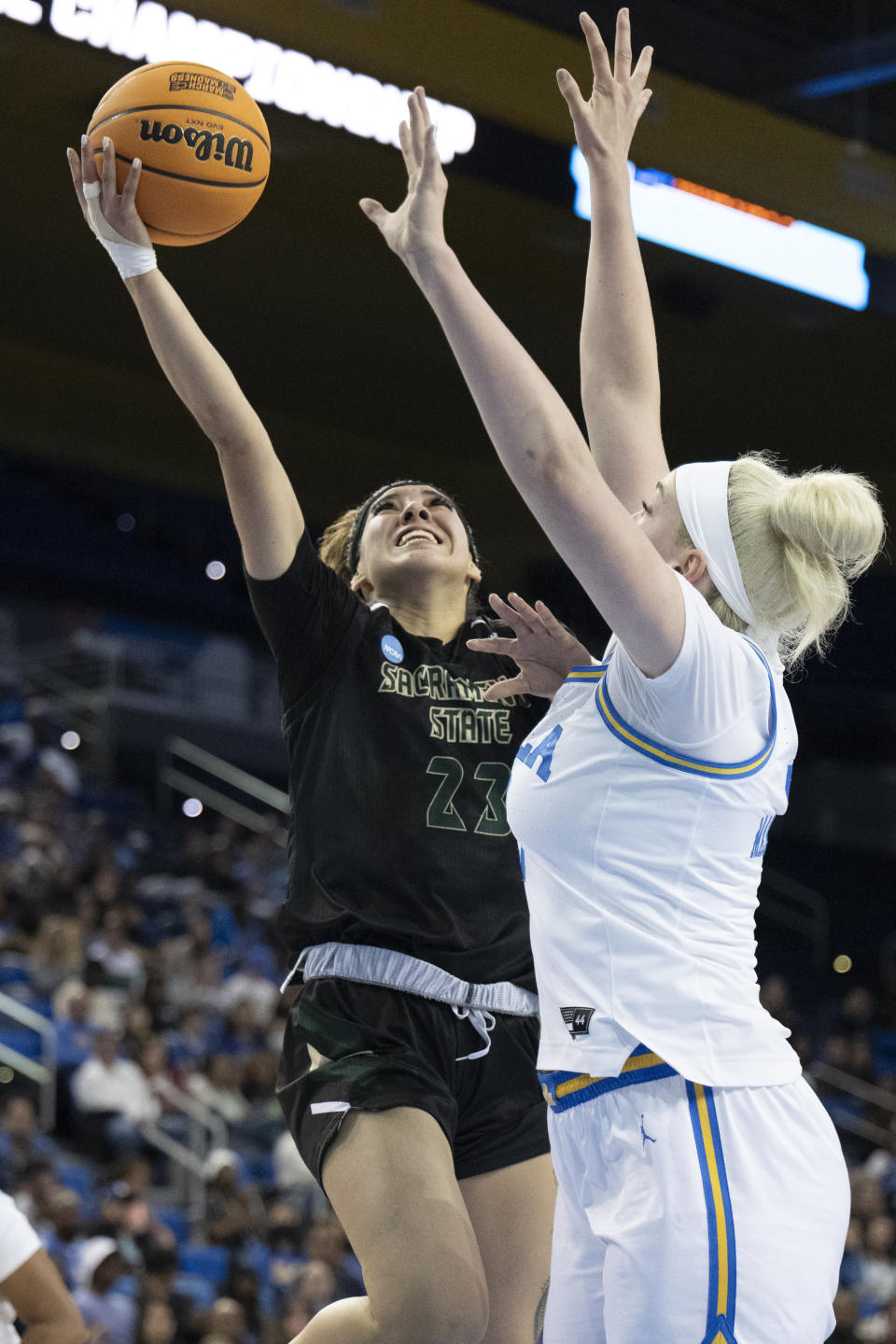 Sacramento State guard Jordan Olivares shoots against UCLA forward Brynn Masikewich during the first half of a first-round college basketball game in the women's NCAA Tournament, Saturday, March 18, 2023, in Los Angeles. (AP Photo/Kyusung Gong)