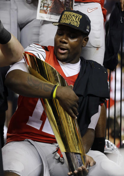 Ohio State&#39;s Cardale Jones holds the championship trophy after the NCAA college football playoff championship game against Oregon Monday, Jan. 12, 2015, in Arlington, Texas. Ohio State won 42-20. (AP Photo/David J. Phillip)