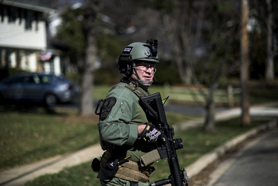 A Virginia State Police officer hunts for accused bank robber Wossen Assaye who escaped Inova Fairfax Hospital early Tuesday in Fairfax, Virginia March 31, 2015. The armed prisoner who escaped from a hospital in Fairfax County in northern Virginia on Tuesday has been captured in Washington, D.C., local police said. (REUTERS/James Lawler Duggan)