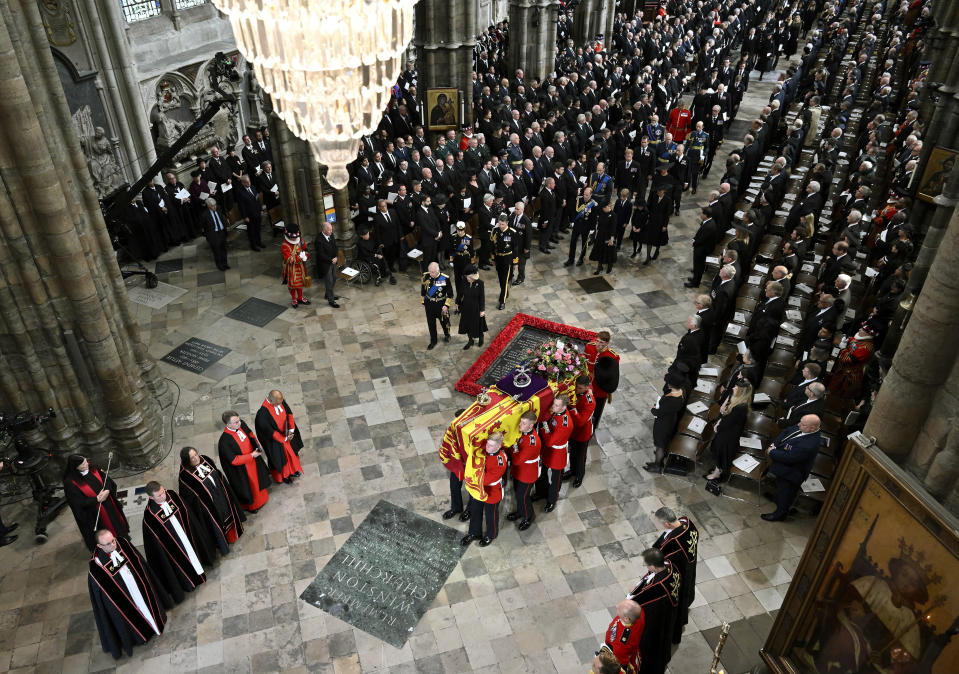 King Charles III, Camilla, the Queen Consort and other members of the Royal family follow behind the coffin of Queen Elizabeth II, draped in the Royal Standard with the Imperial State Crown and the Sovereign's orb and sceptre, as it is carried out of Westminster Abbey after her State Funeral, in London, Monday Sept. 19, 2022. The Queen, who died aged 96 on Sept. 8, will be buried at Windsor alongside her late husband, Prince Philip, who died last year. (Gareth Cattermole/Pool Photo via AP)