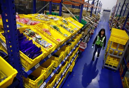 An employee works at RedMart's fulfillment centre in Singapore September 22, 2017. Picture taken September 22, 2017. REUTERS/Edgar Su