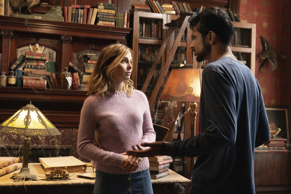 This image released by CBS shows Rose McIver, left, and Utkarsh Ambudkar in a scene from the comedy series "Ghosts." (Cliff Lipson/CBS via AP)