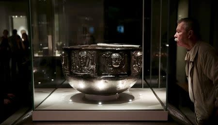 A visitor looks at The Gundestrup cauldron displayed in the "Celts: art and identity" exhibition at the British Museum in London, Britain in this September 23, 2015 file photo. REUTERS/Suzanne Plunkett/Files