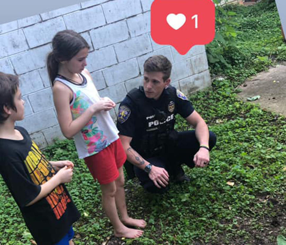 Pictured is Florence Alabama police officer Justin Whitten who comforted nine-year-old Makayla Hogue whom he found crying when her cat was run over.