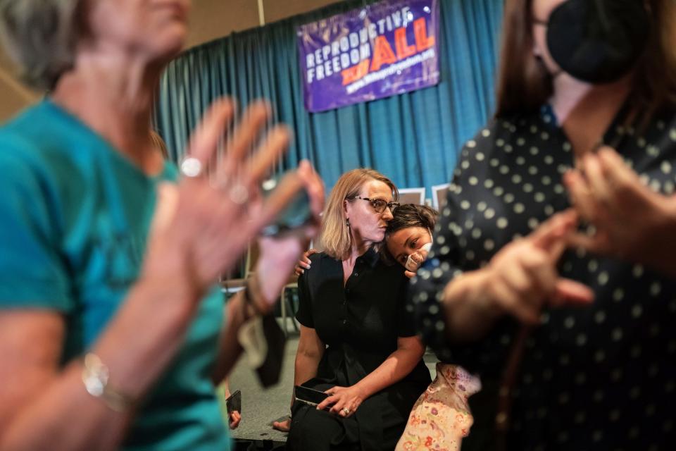 American Civil Liberties Union of Michigan Executive Director Loren Khogali rests her head on her daughter Hala Khogali while sitting on the stage after speaking during a news conference for Reproductive Freedom For All at the Lansing Center in downtown Lansing on Monday, July 11, 2022. The Reproductive Freedom For All organization, along with its affiliates, turned in 753,759 signatures to the Michigan Secretary of State to qualify for the Nov. 8, 2022, ballot to preserve abortion access and reproductive freedom in Michigan.