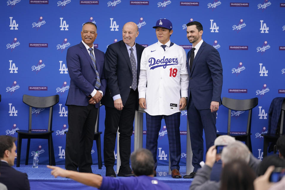 Yoshinobu Yamamoto, second from right, poses for photos with the team's leadership, including manager Dave Roberts, left, president and CEO Stan Kasten, second from left, and Executive Vice President and General Manager Brandon Gomes, right, during his introduction as a new member of the Los Angeles Dodgers baseball team Wednesday, Dec. 27, 2023, in Los Angeles. (AP Photo/Ashley Landis)