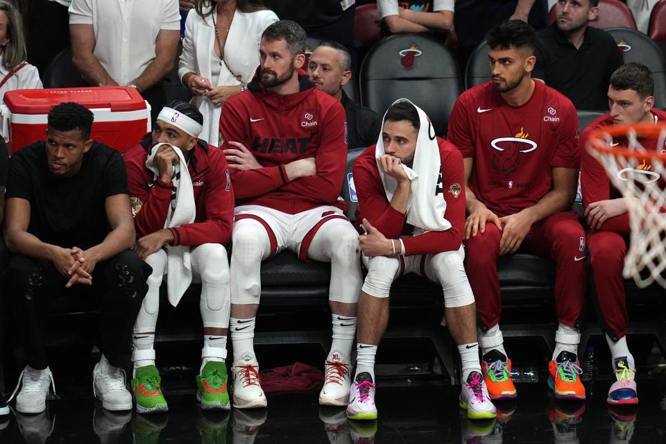 Miami Heat players look on from the bench during the second half of Game 4