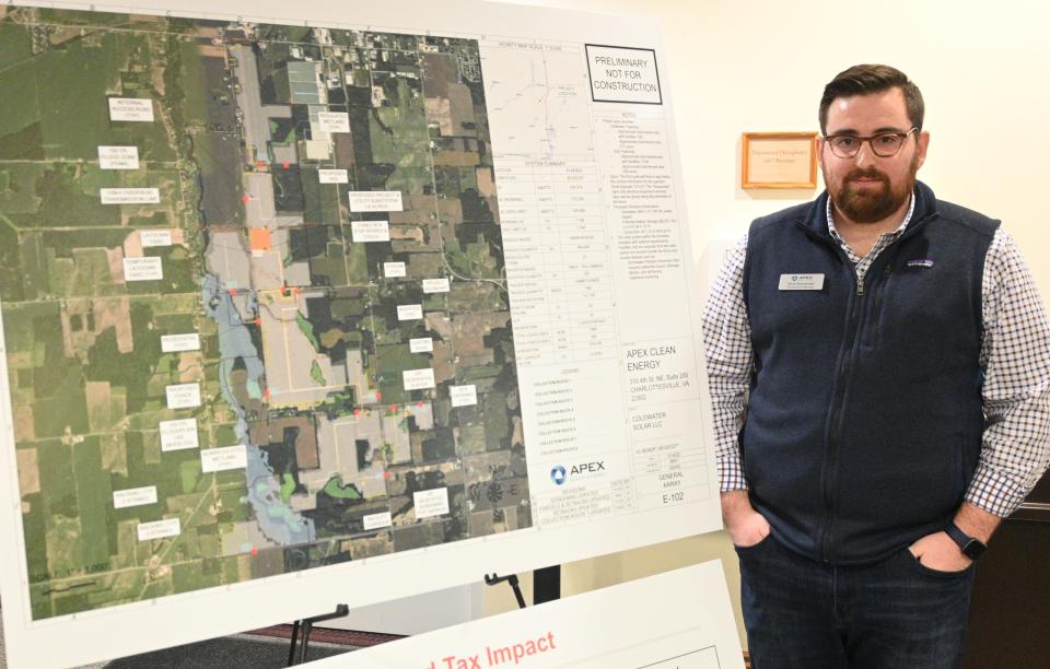 Nick Alexander, development manager at Apex Clean Energy, displays the layout for a 150-megawatt solar farm in Coldwater and Ovid townships.
