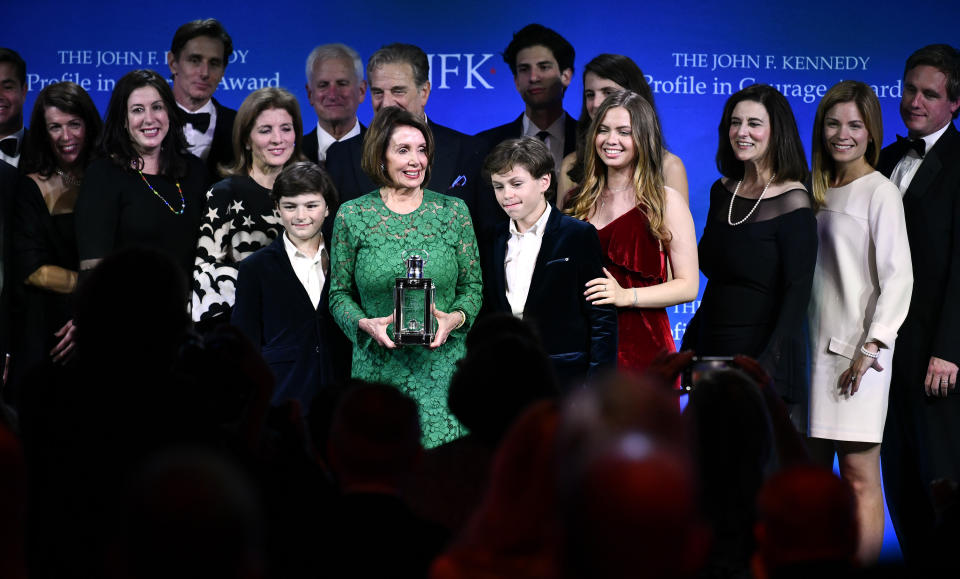 Speaker of the House Nancy Pelosi, D-Calif., center, stands with family members of hers and Kennedy's, as she receives the 2019 John F. Kennedy Profile in Courage Award, Sunday, May 19, 2019, at the John F. Kennedy Presidential Library and Museum in Boston. (AP Photo/Josh Reynolds)