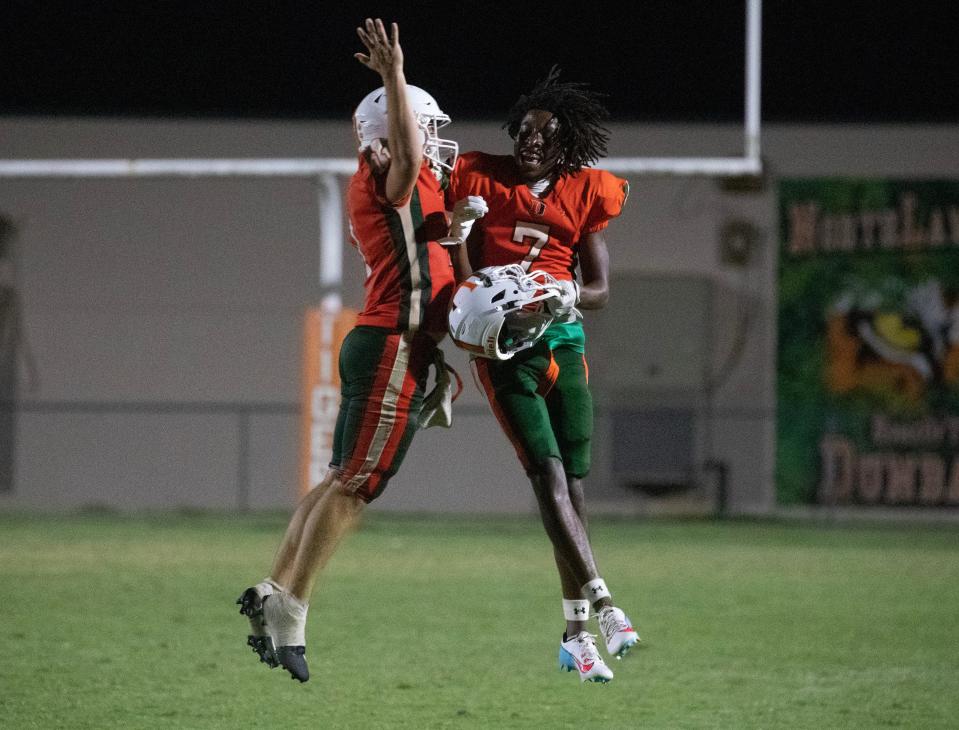 Dunbar quarterback Austin Price and Hezekiah Jones celebrates their win over Fort Myers on Friday, Sept. 15, 2023, at Dunbar High School. Dunbar won 40-39 in double overtime.