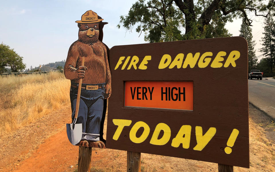 A roadside sign outside Colfax, Calif., warns of the threat of wildfires on Aug. 4. (Photo: Jim Christie/Reuters)