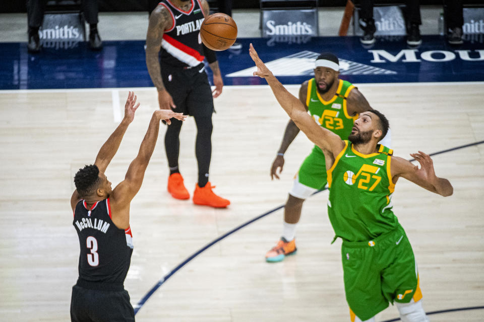 Portland Trail Blazers guard CJ McCollum (3) shoots over Utah Jazz center Rudy Gobert (27) during the first half of an NBA basketball game Thursday, April 8, 2021, in Salt Lake City. (AP Photo/Isaac Hale)