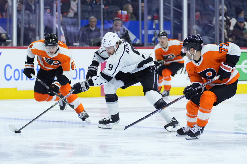 Los Angeles Kings' Adrian Kempe (9) skates against Philadelphia Flyers' Tony DeAngelo (77) and Travis Sanheim (6) during the third period of an NHL hockey game, Tuesday, Jan. 24, 2023, in Philadelphia. (AP Photo/Matt Slocum)