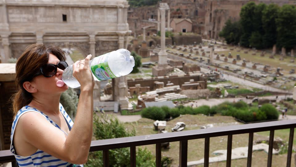 A woman in Rome drinks water near the Roman Forum. - Remo Casilli/Reuters