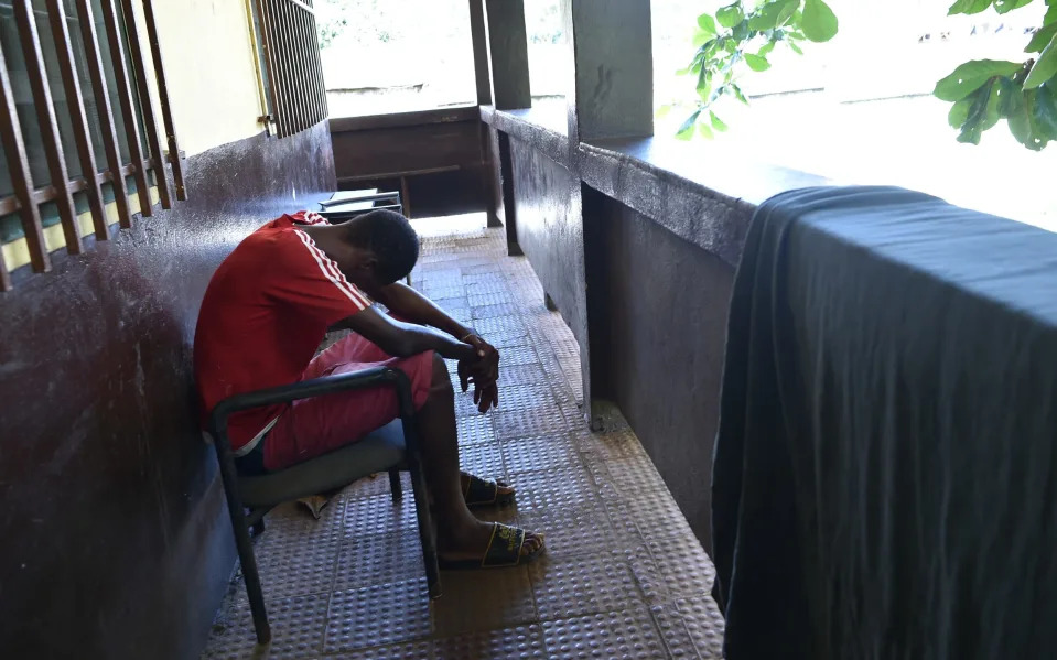 An addict bows head down at the city of rest rehbilitation center in Freetown