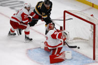 Boston Bruins right wing Garnet Hathaway (21) scores the game-winning goal past Detroit Red Wings goaltender Magnus Hellberg (45) and center Dylan Larkin (71) during the third period of an NHL hockey game, Saturday, March 11, 2023, in Boston. (AP Photo/Mary Schwalm)