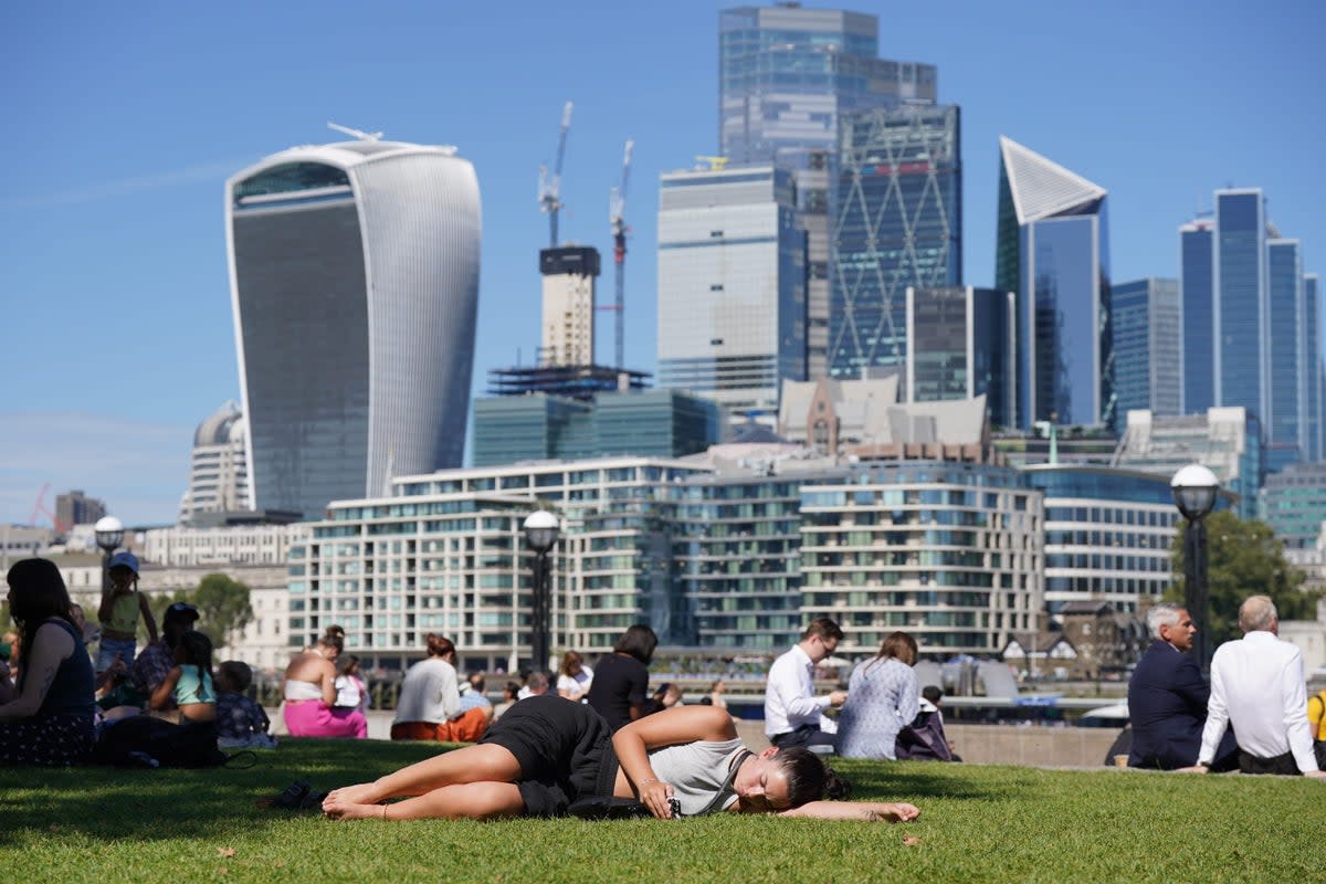 People enjoy the warm weather in Potters Fields Park in London (PA Wire)