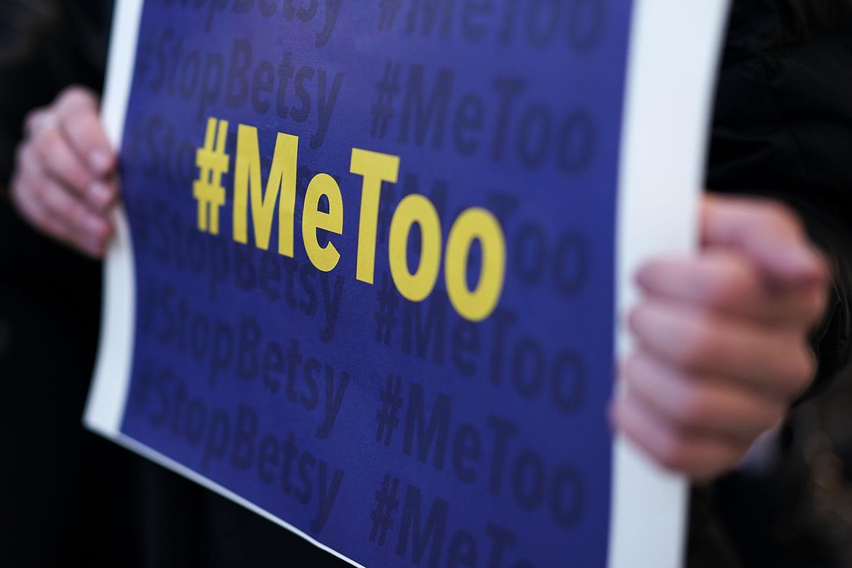 An activist holds a #MeToo sign during a news conference on a Title IX lawsuit outside the Department of Education January 25, 2018 in Washington, DC.