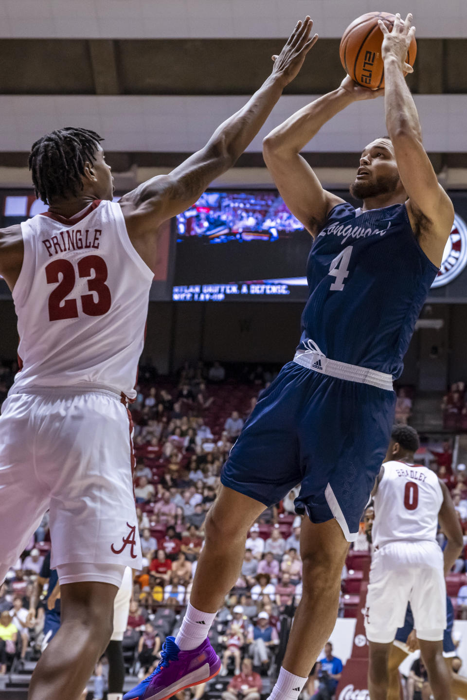 Alabama forward Nick Pringle (23) defends against Longwood forward Zac Watson (4) during the first half of an NCAA college basketball game Monday, Nov. 7, 2022, in Tuscaloosa, Ala. (AP Photo/Vasha Hunt)