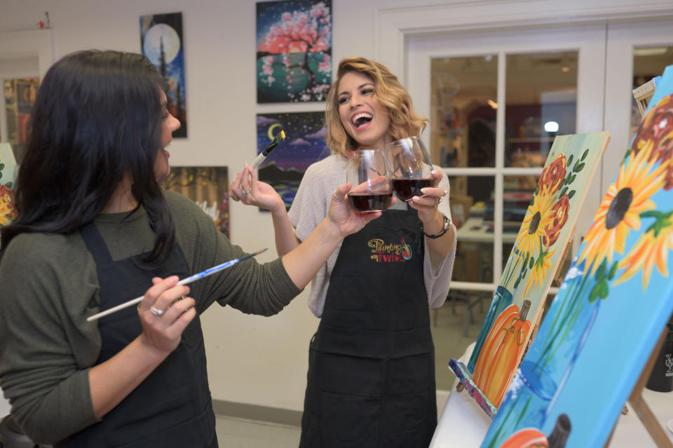 This 2019 photo provided by Painting with a Twist shows some patrons during at a Painting with a Twist event in Mandeville, La. In recent years, the interactive painting industry has become a global sensation. Around the world, adults can spend their nights out learning to paint in a relaxed, BYOB setting. Thousands of franchises exist to help us all unleash our inner creative. (Painting with a Twist via AP)
