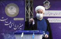 In this photo released by the official website of the office of the Iranian Presidency, President Hassan Rouhani casts his ballot for the presidential elections at the Interior Ministry in Tehran, Iran, June 18, 2021. Iran began voting Friday in a presidential election tipped in the favor of a hard-line protege of Supreme Leader Ayatollah Ali Khamenei, fueling public apathy and sparking calls for a boycott in the Islamic Republic. (Iranian Presidency Office via AP)