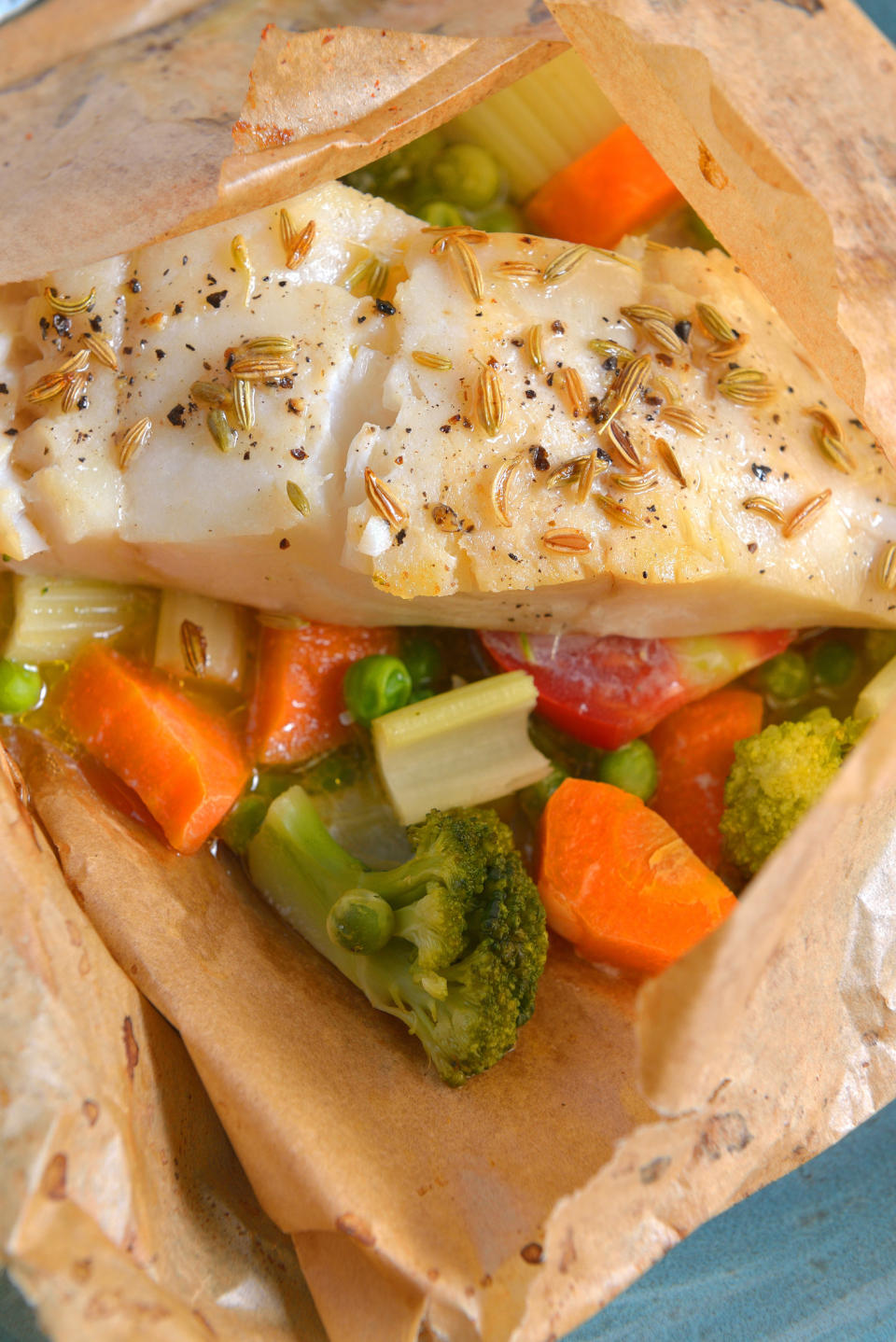 A piece of fish and vegetables in parchment paper