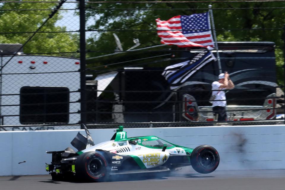 Juncos Hollinger Racing driver Callum Ilott (77) crashes in the second turn Sunday, May 29, 2022, during the 106th running of the Indianapolis 500 at Indianapolis Motor Speedway