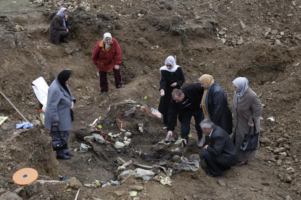 Bosnian Muslim women who lost their relatives looks at mass grave in attempt to identify ther relatives in a mass grave in the village of Cerska near the eastern Bosnian town of Milici , 160 kms northeast of Sarajevo,Bosnia, on Wednesday, Dec. 08, 2010. Regardless of how the Russian war of aggression in Ukraine ends, getting justice for extreme human rights abuses suffered during the conflict will inevitably be a long and painful process for those who survive it to tell the truth about the atrocities they had witnessed and to mourn their dead. Or so say the survivors of Bosnia’s 1992-95 internecine war who had suffered unspeakable horrors in the 1990s conflict and dedicated the ensuing years of their lives to the re-telling and re-living their traumatic experiences in hope of bringing those responsible to justice. (AP Photo/Amel Emric)