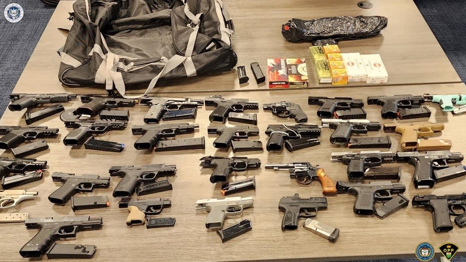 The 106 firearms confiscated in Ontario mark the largest seizure of handguns and assault-style rifles in the province's history, police say. (OPP - image credit)