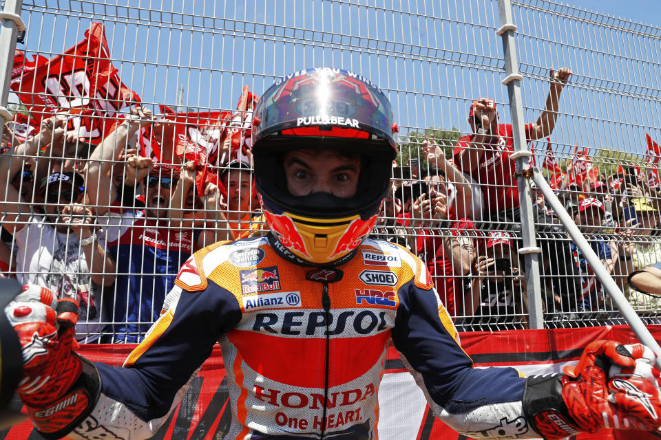 MotoGP rider Marc Marquez of Spain, center, celebrates with fans by the side of the track after winning the Spanish Motorcycle Grand Prix at the Angel Nieto racetrack in Jerez de la Frontera, Spain, Sunday, May 5, 2019. (AP Photo/Miguel Morenatti)