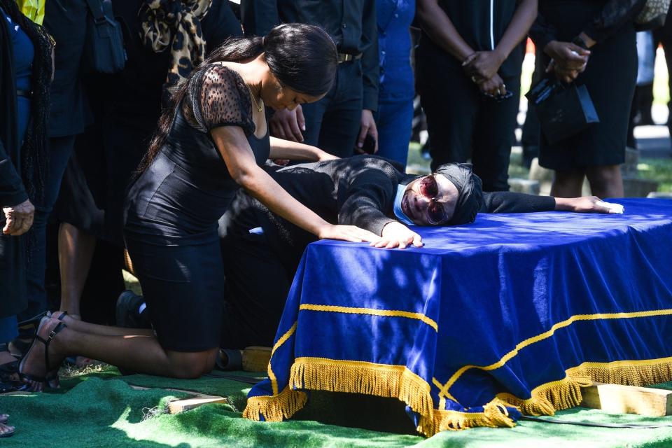 Khafi Kareem with her mother at her brother's funeral (PA)