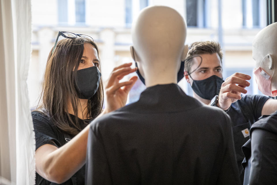 Boutique shopkeepers put protective masks on mannequins before they open their store for the first time since March in Berlin, Germany. (Maja Hitij/Getty Images)