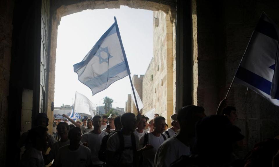 Youths wave Israeli flags during a parade marking Jerusalem Day.