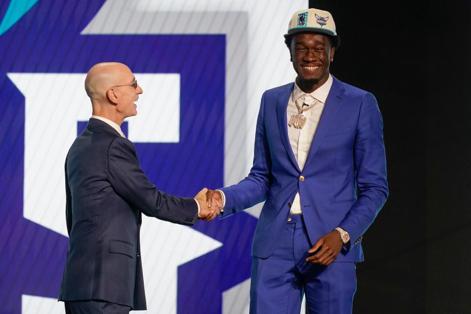 Mark Williams, right, is congratulated by NBA Commissioner Adam Silver after being selected the Charlotte Hornets in the NBA basketball draft, Thursday, June 23, 2022, in New York. (AP Photo/John Minchillo)