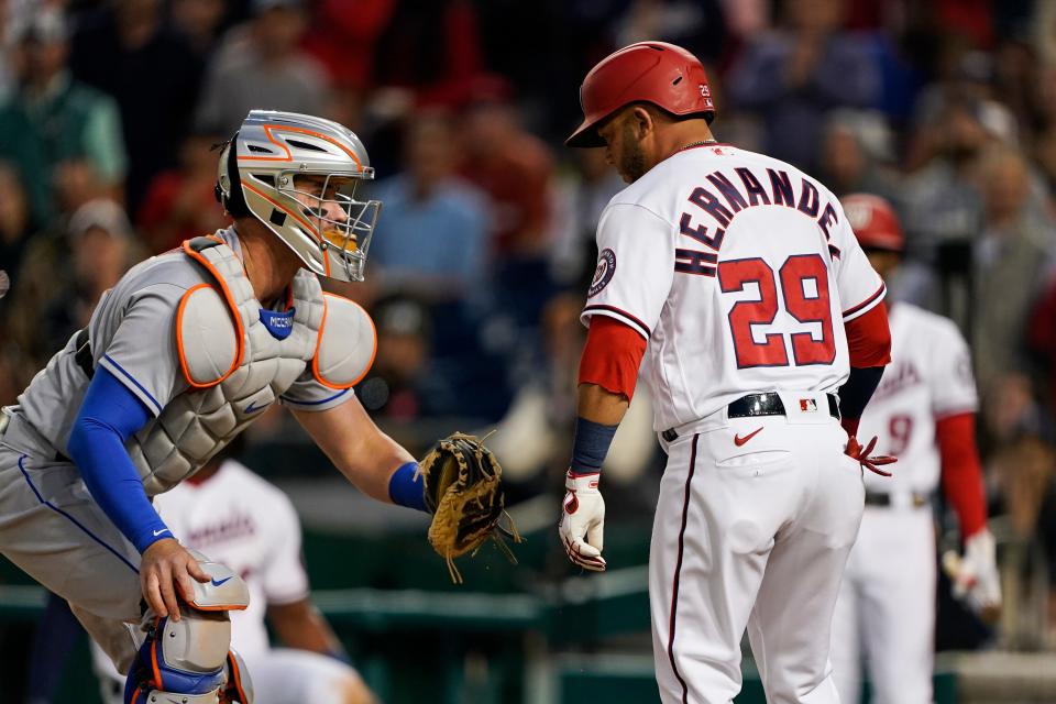 New York Mets catcher James McCann, left, tags out Washington Nationals' Yadiel Hernandez as he tries to come home during the fourth inning of a baseball game at Nationals Park, Tuesday, May 10, 2022, in Washington.