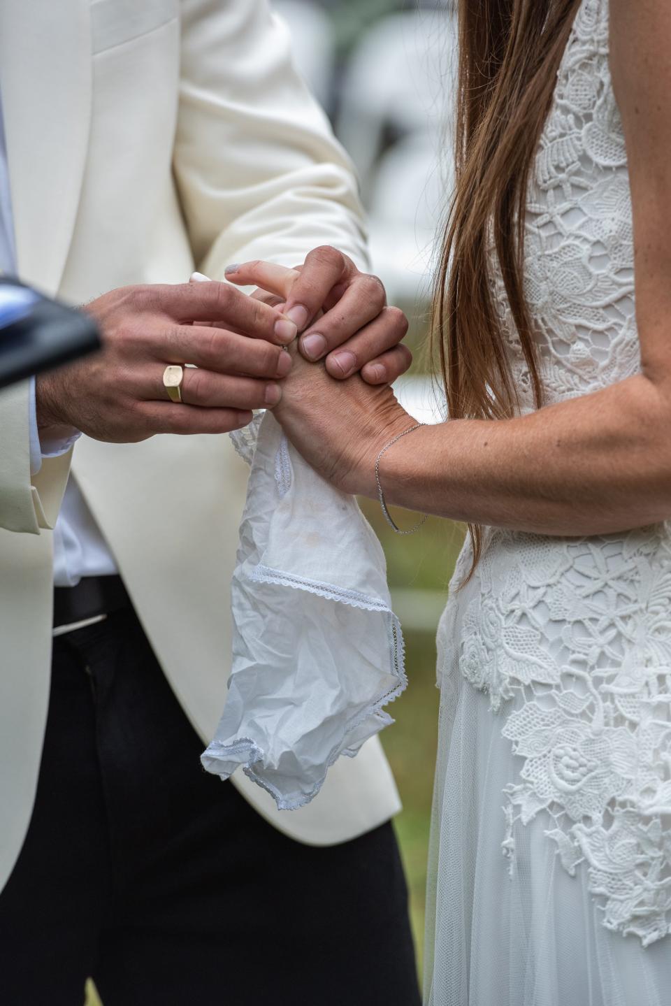 Anthony Ferraro places a wedding ring on Kelly Anne's finger at their wedding.