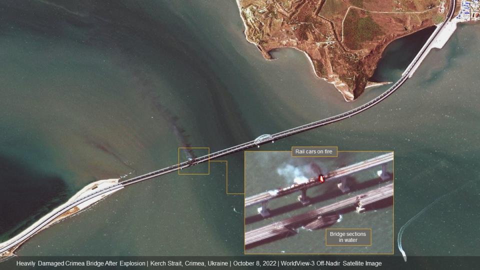 The aftermath of a key bridge connecting Crimea and Russia after it was hit by an explosion (Satellite image/2022 Maxar Technologies)