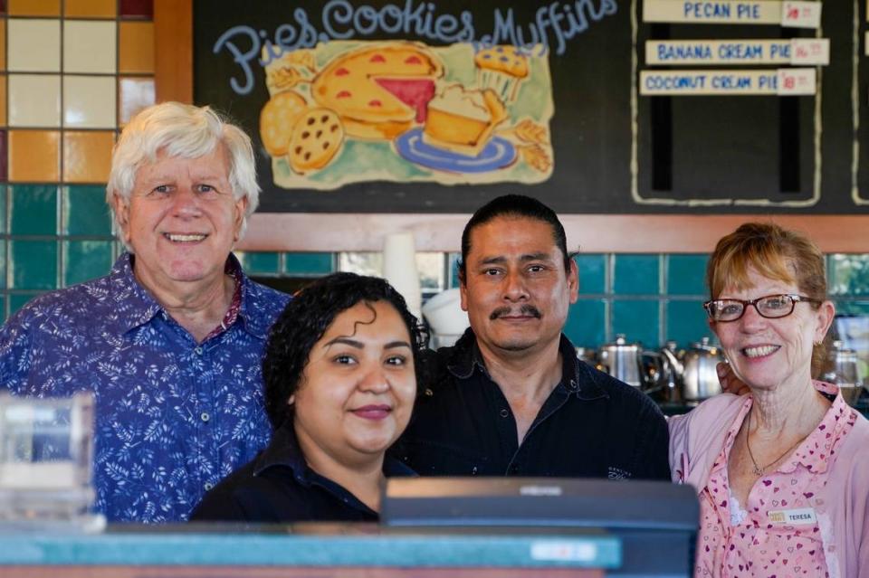 Coco’s Bakery Restaurant owner Larry Puder, left, stands with his staff on the second-to-last day of the Pismo Beach restaurant’s operation, Feb. 14, 2023.